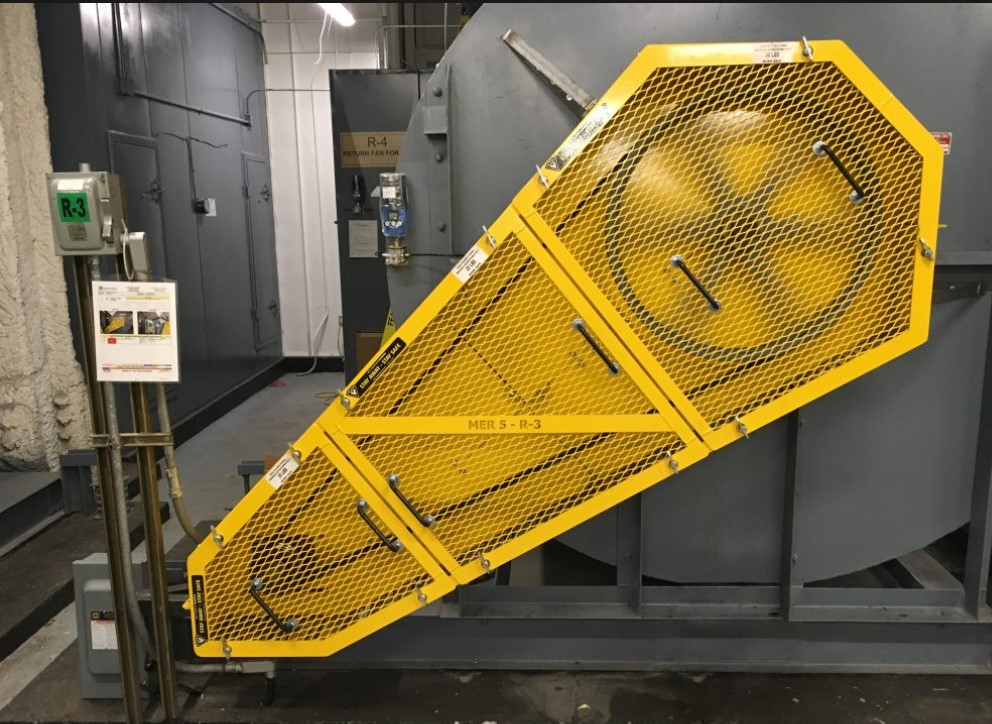 Guarda de seguridad amarilla instalada en máquina de planta metalúrgica minera
